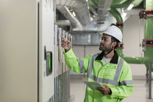 Close-up of industrial control panel wiring showing a PLC and SCADA system